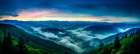 Mountain landscape at sunrise with low clouds. (AI Generated) Art Print